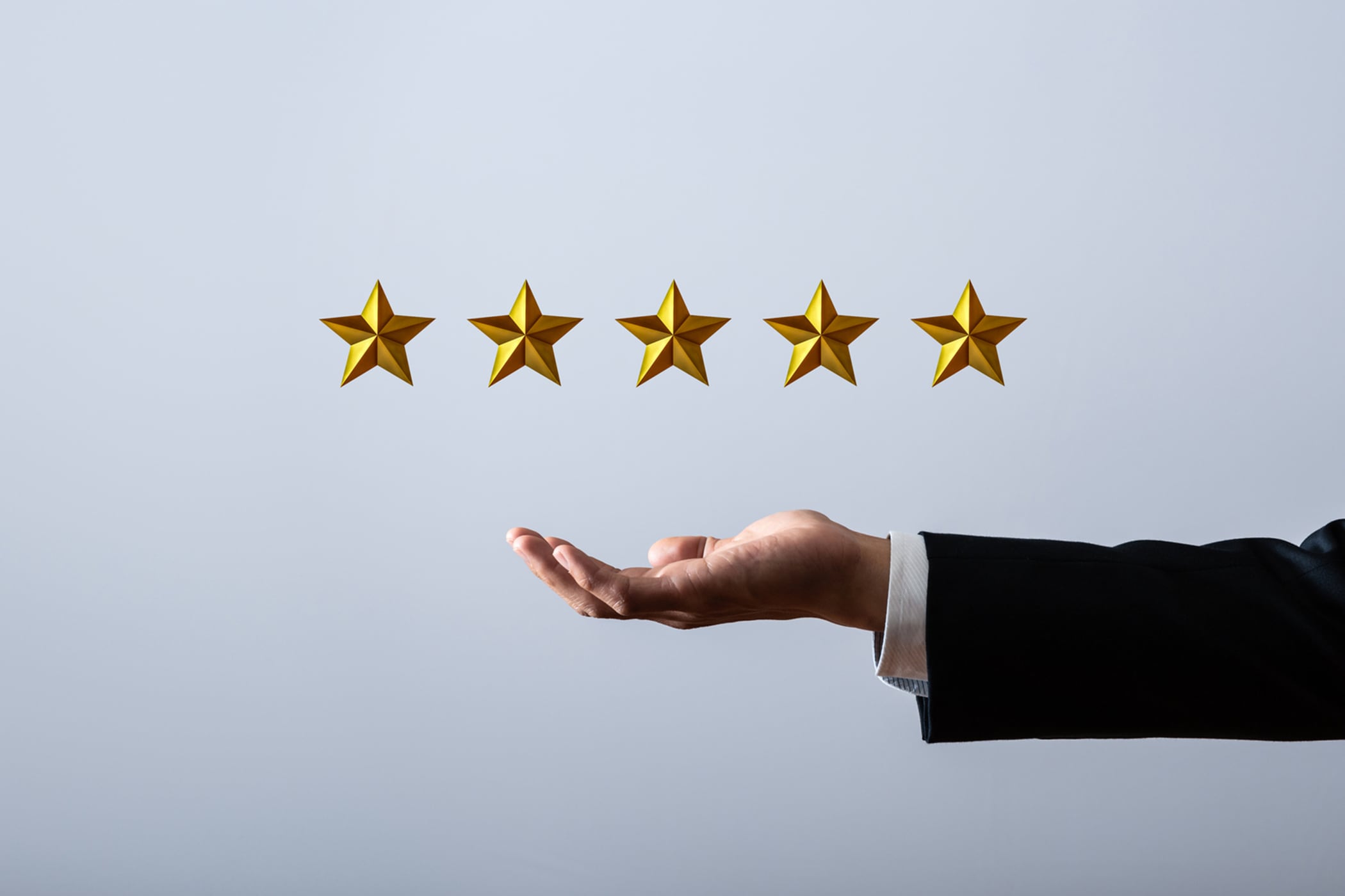 浮かぶ五つ星とビジネスヒューマンの腕