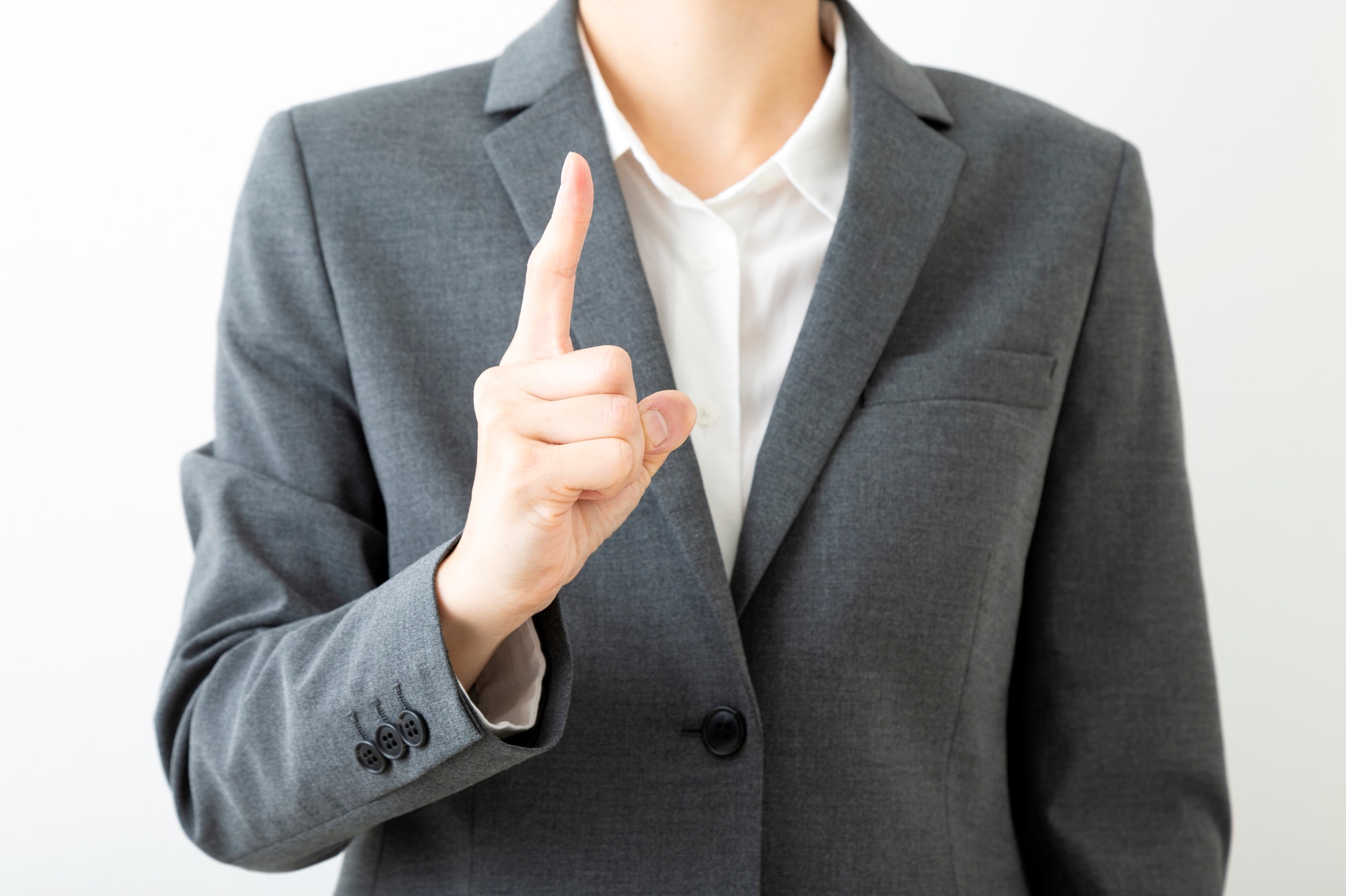 人差し指を立てるビジネスヒューマン